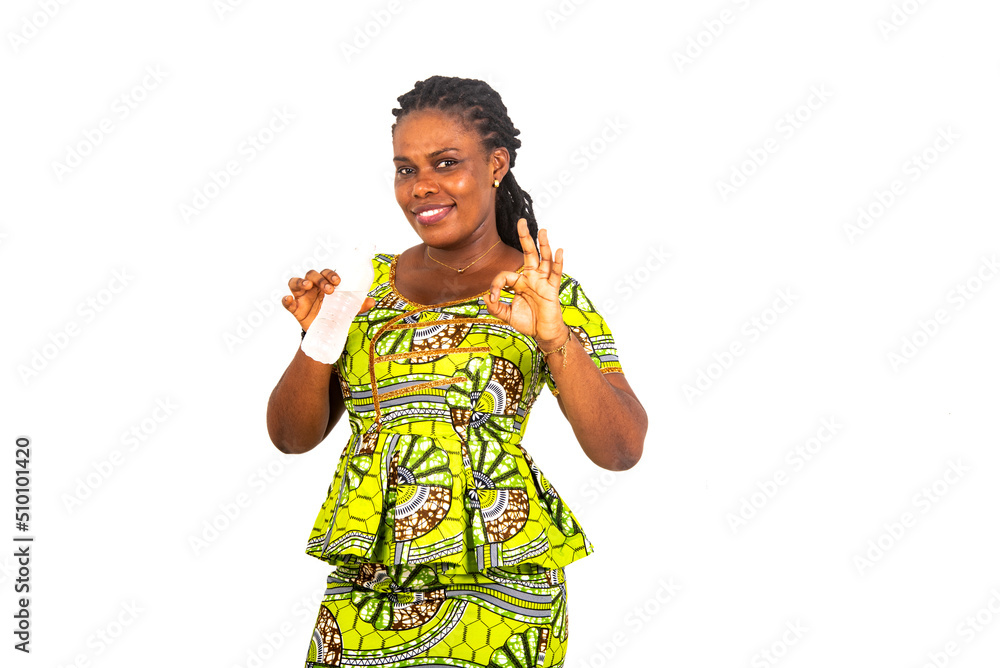 young woman holding water bottle and showing okay gesture smiling. young woman holding water bottle and showing okay gesture smiling.