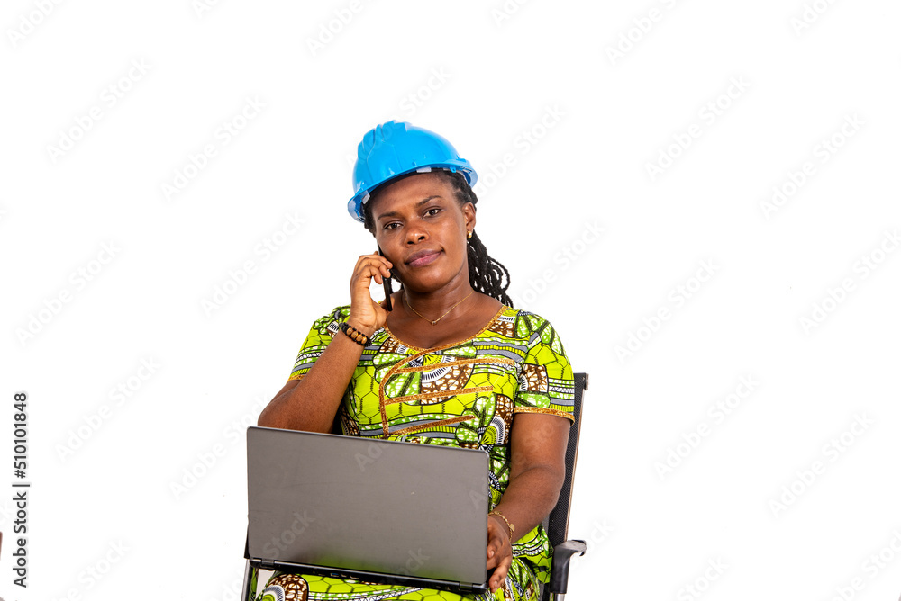 female engineer talking on mobile phone and working with laptop. female engineer talking on mobile phone and working with laptop.