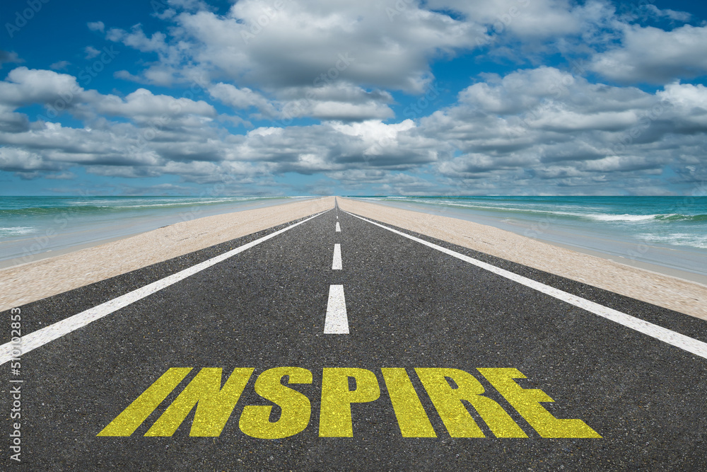 Inspire text on a highway leading to success for inspirational concept.