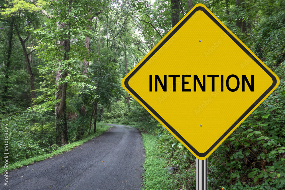 Intention sign with path in nature for motivational concept.