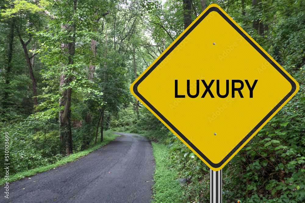Luxury road sign with path leading into the forest.