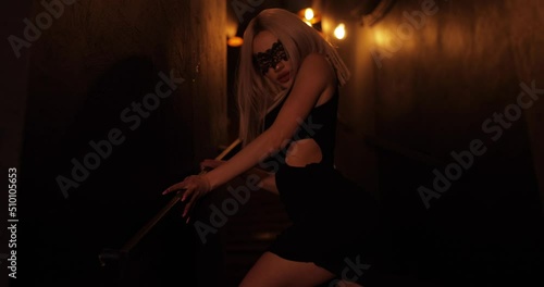 Sexy attractive frisky woman in dress posing in the night bar