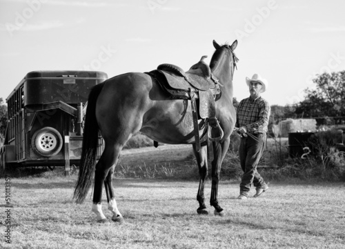 Western horsemanship groundwork with young mare horse on Texas ranch with cowboy in black and white.