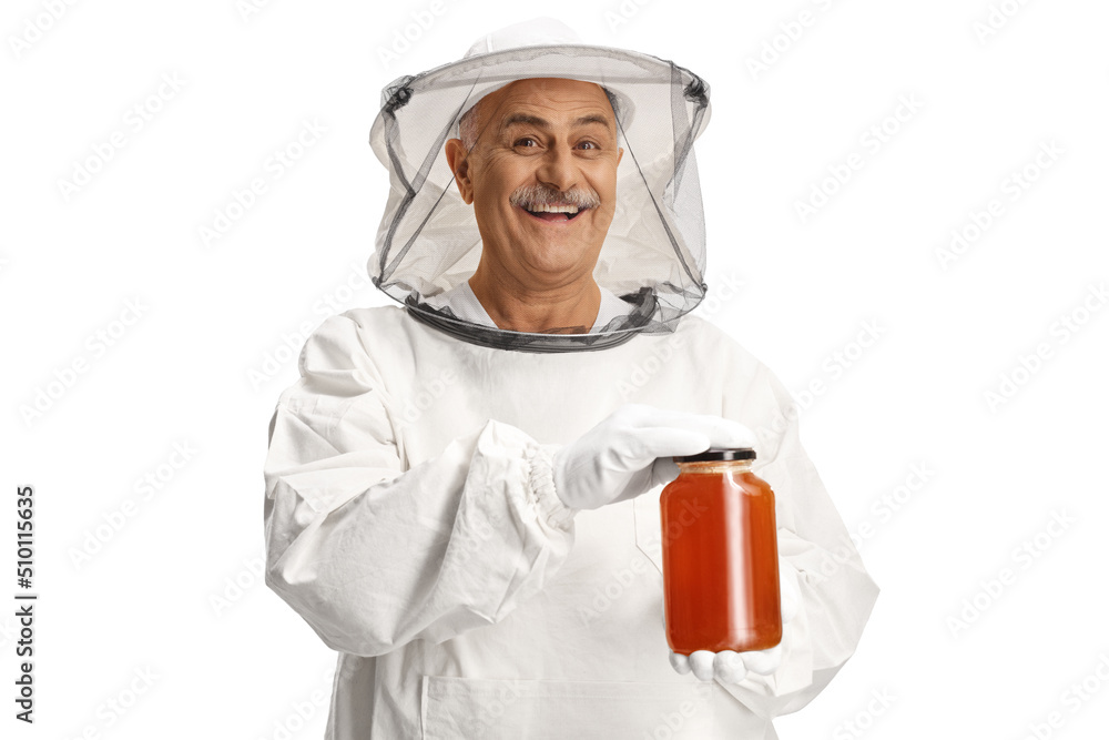 Bee keeper in a uniform holding a honey jar Bee keeper in a uniform holding a honey jar