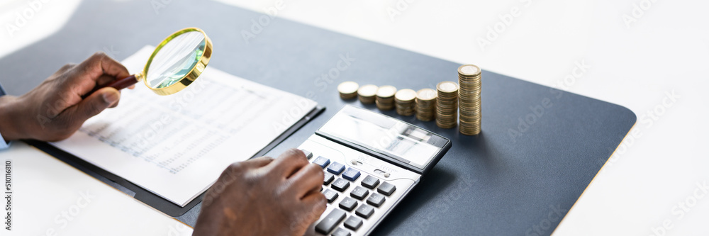 Person Calculating Invoice On Desk Person Calculating Invoice On Desk