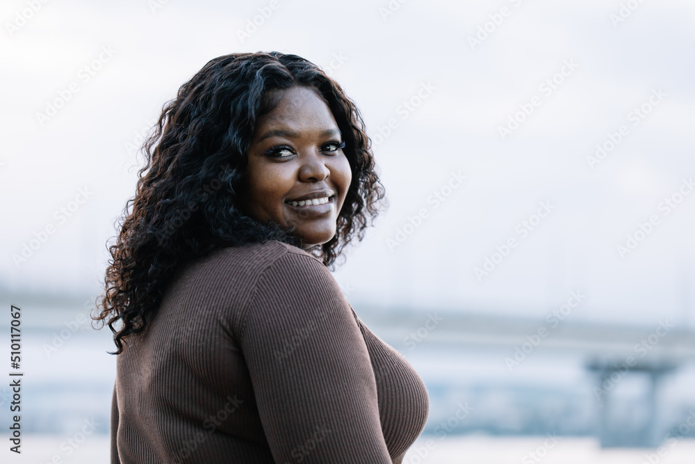 African american dark skinned plus size model posed in a blue