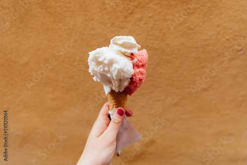 Woman holds a gelato in her left hand