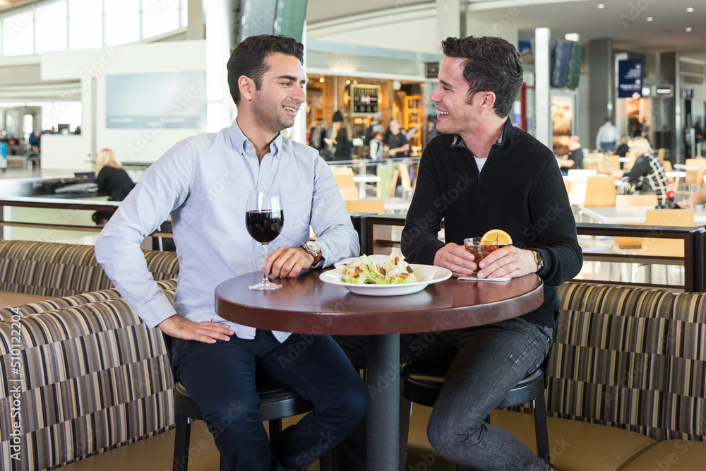 Two Men Enjoy a Pre-Flight Beverage at an Airport Two Men Enjoy a Pre-Flight Beverage at an Airport