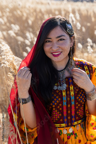 Young Afghani Woman Portrait in Traditional Dress in field  photo