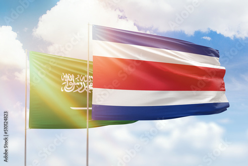 Sunny blue sky and flags of costa rica and saudi arabia