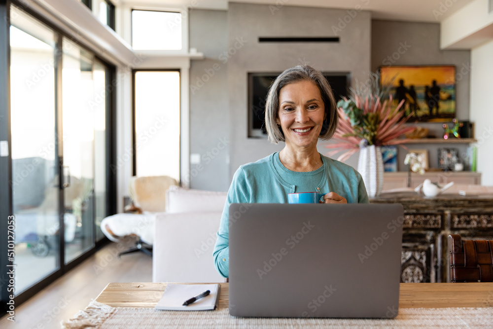 Retired Woman Drinks Coffee While Video Chatting Retired Woman Drinks Coffee While Video Chatting