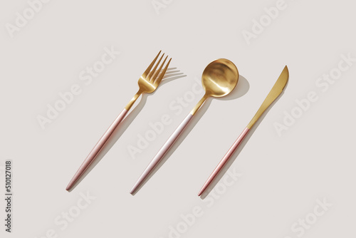 Set of elegant golden fork, spoon and knife photo