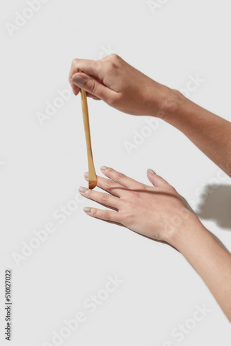 Blade of golden table knife between female fingers photo