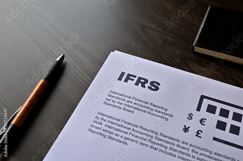 There is dummy documents that created for the photo shoot on the desk about IFRS. photo