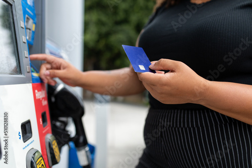Person Types In Pin Code For Debit Card At Gas Pump photo