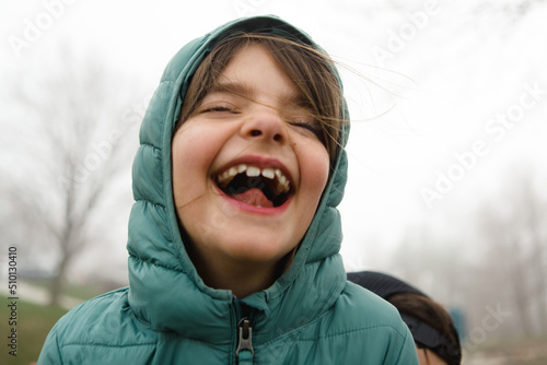 Girl throws her head back and laughs photo