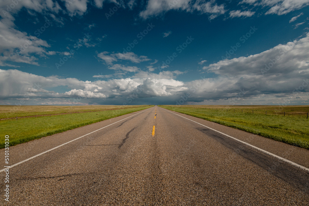 A road cuts across the prairies. A road cuts across the prairies.