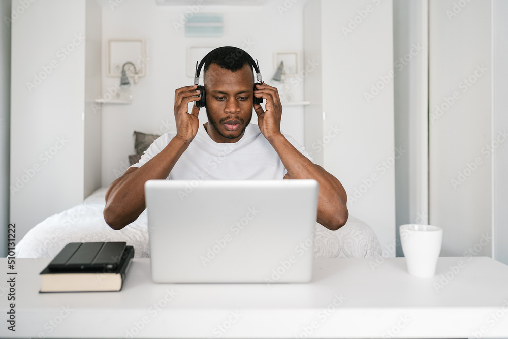 Serious black man having video chat on laptop Serious black man having video chat on laptop