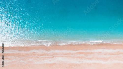 aerial photo of a sandy beach with azure water photo
