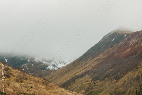 Earthy grasslands in the foggy highlands in Scotland, Forth William.  photo