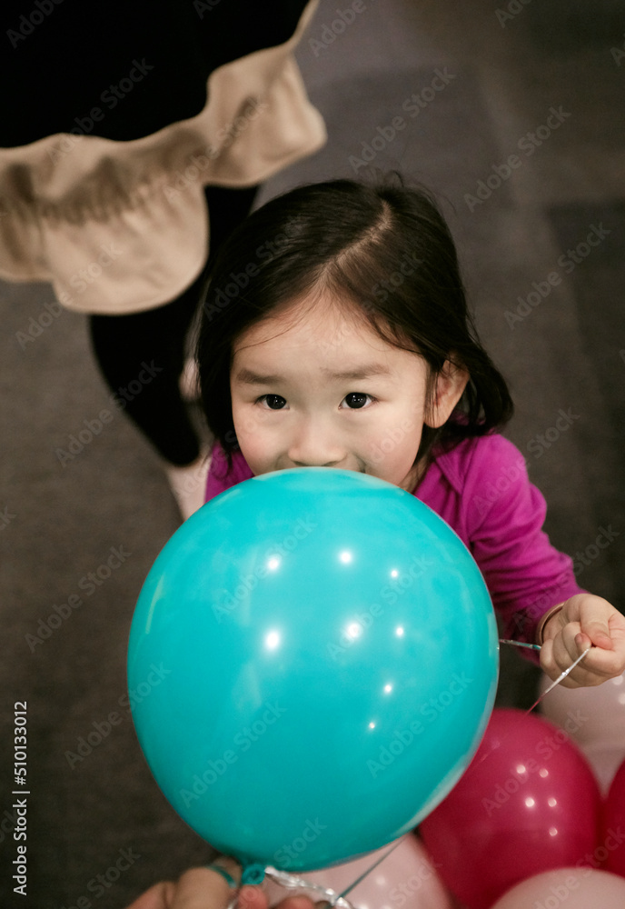 Adorable little Asian girl playing in the stack of bubble balls Adorable little Asian girl playing in the stack of bubble balls