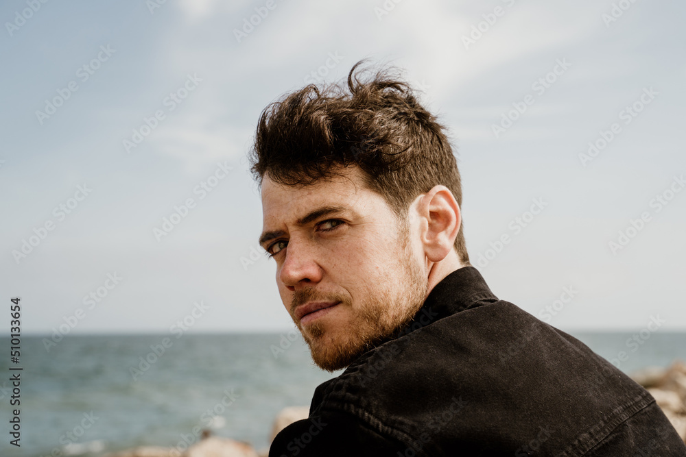 Close-up Fashion Portrait of handsome man outdoors by the beach Close-up Fashion Portrait of handsome man outdoors by the beach