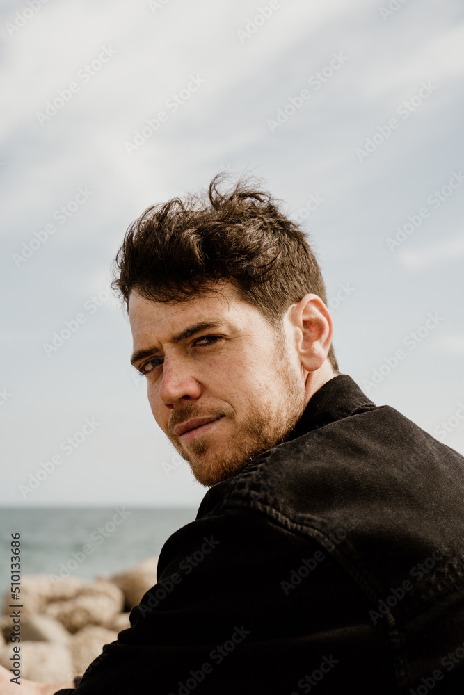 Portrait of handsome man outdoors on pier by the sea Portrait of handsome man outdoors on pier by the sea