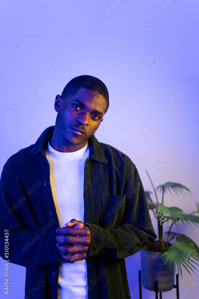 Portrait Of A Man Under Coloured Gel Lights And Ornamental Plant Portrait Of A Man Under Coloured Gel Lights And Ornamental Plant