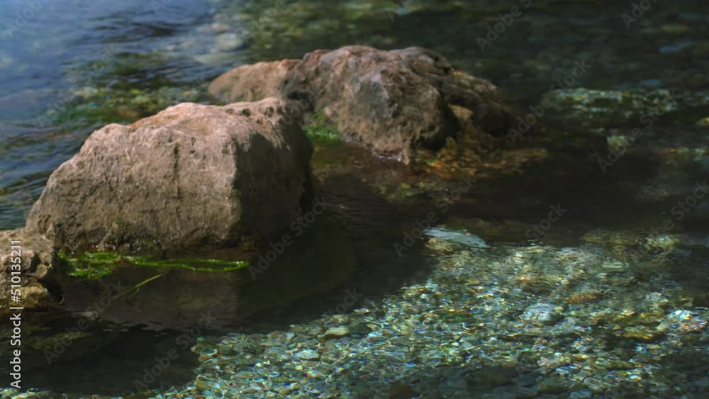 Fresh water is flowing between rocks in slow motion. Fresh water is flowing between rocks in slow motion.