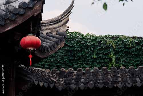 Traditional Chinese architecture covered with creeper leaves photo