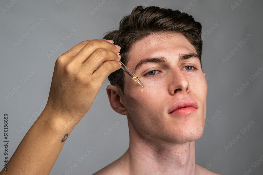 Serum dripping on male face, male skin care Serum dripping on male face, male skin care
