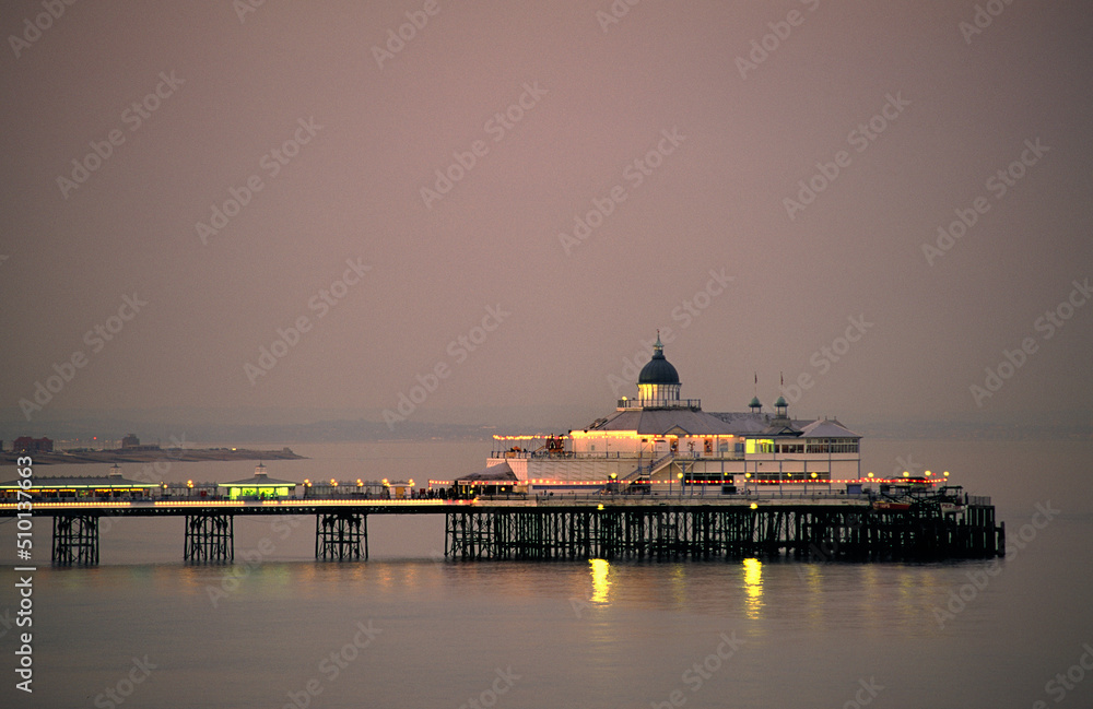 Eastbourne Pier on coast of English Channel, East Sussex, England. Summer evening.