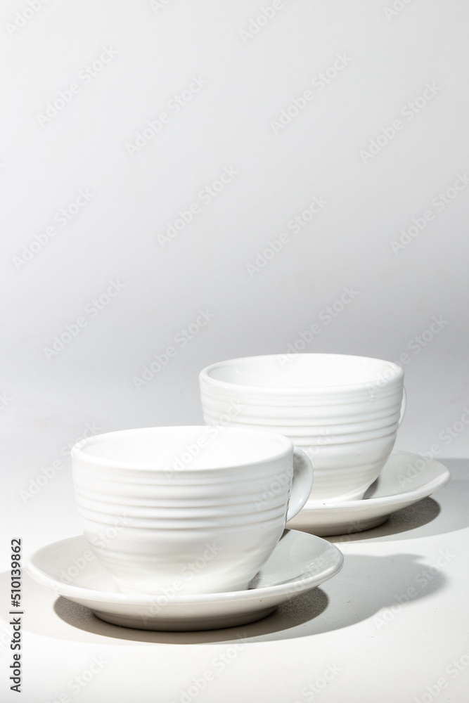 Isolated empty two white cups ready for coffee and a white background Isolated empty two white cups ready for coffee and a white background