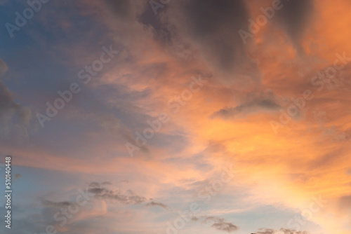 Beautiful sunset and sunrise twilight blue, orange sky, and clouds in the morning above clouds with dramatic light. © pomphotothailand