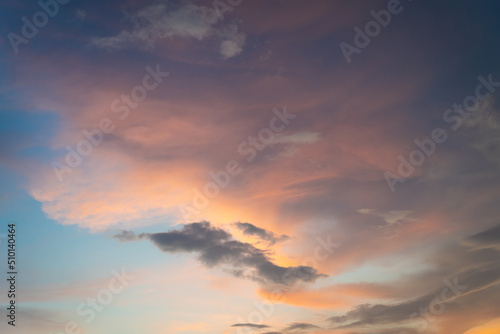Beautiful sunset and sunrise twilight blue, orange sky, and clouds in the morning above clouds with dramatic light. © pomphotothailand