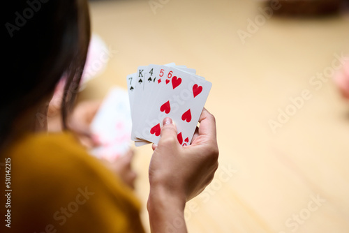 Crop woman examining cards