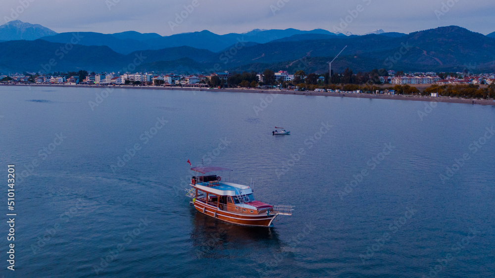 excursion boat returning to the dock at the dusk excursion boat returning to the dock at the dusk