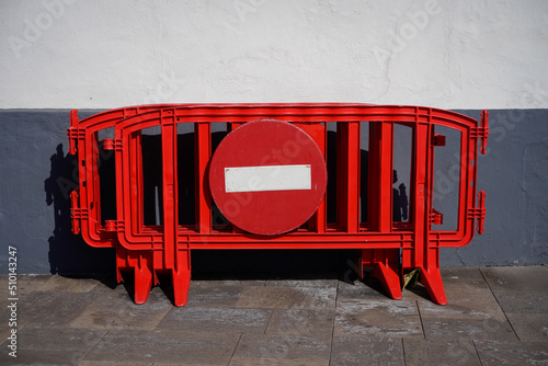 Red fence with forbidden sign. photo