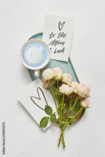 Tray with flowers, cards and blue cappuccino photo