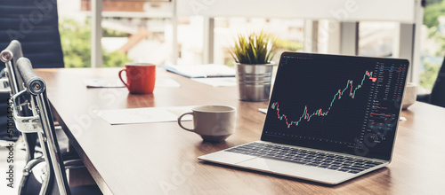 Stock market data chart analysis by ingenious computer software . Investment application display stock market chart on the computer screen and advise trading decision .