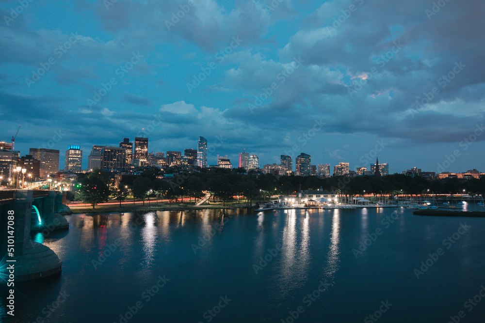 Boston city Charles River at dusk with urban skyline and skyscrapers.