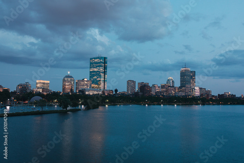 Boston city Charles River at dusk with urban skyline and skyscrapers.