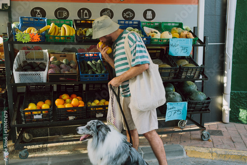 Man smelling oranges before shopping them photo