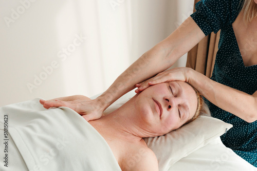 Senior woman having cosmetology massage at spa.