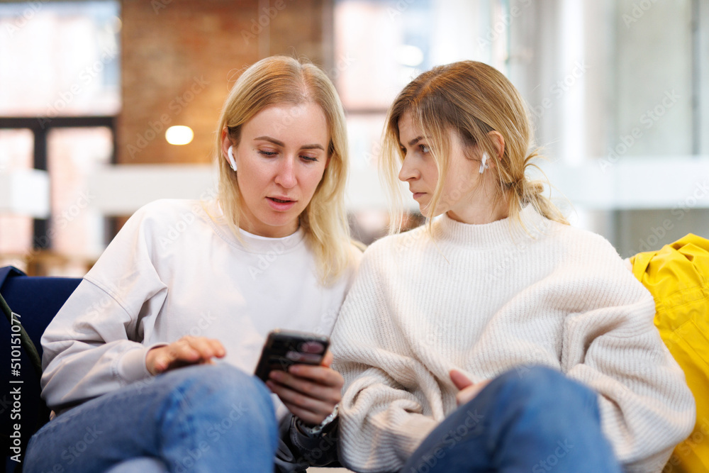 Girls discussing news during meet in public place Girls discussing news during meet in public place