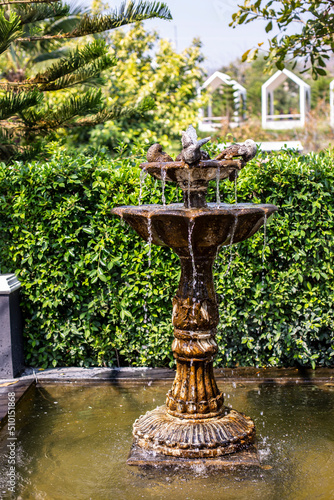 Photo of fountain in park and blurred background.