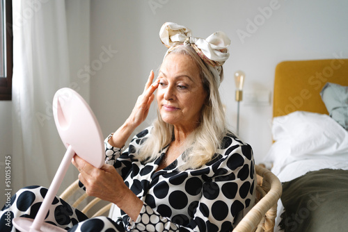 Mature woman morning facial routine photo