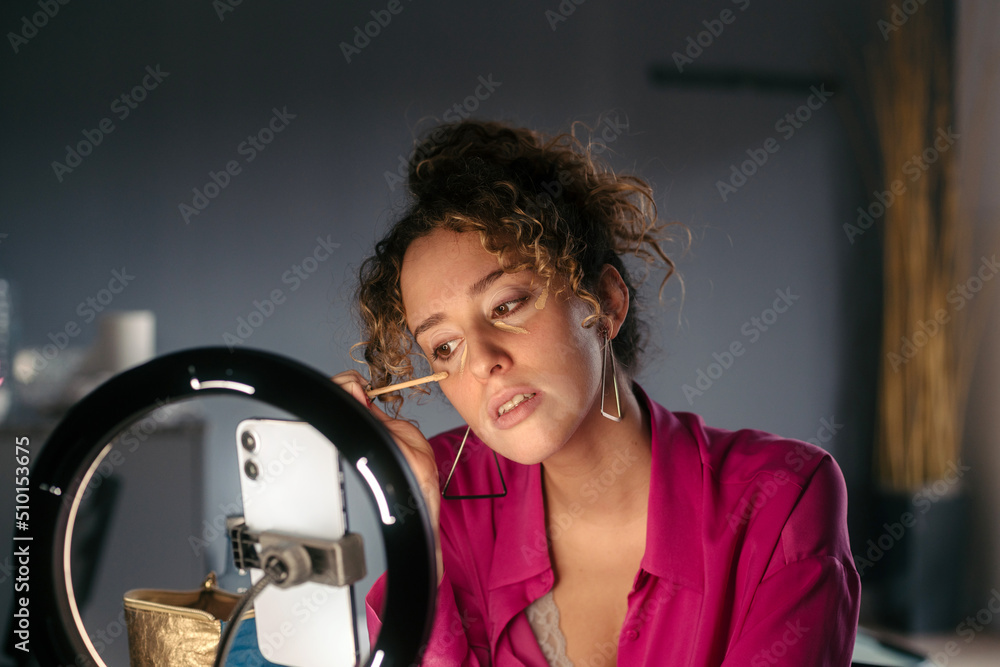 Woman applying makeup Woman applying makeup