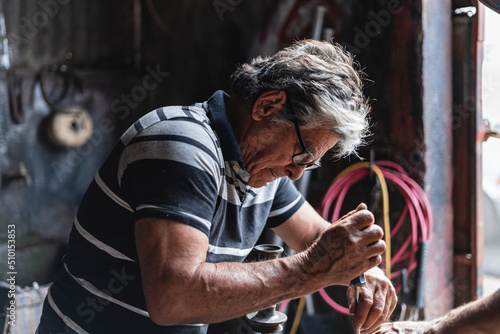 Older man repairing a machine