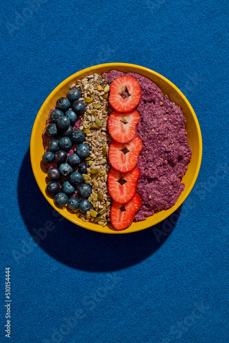 acai bowl on a blue cloth surface photo